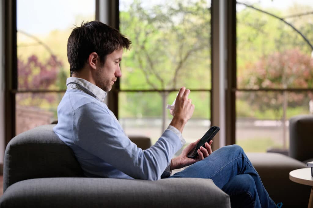 A patient using his phone for onboard a new treatment