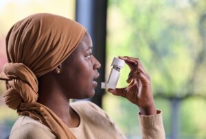 A female patient using a connected inhaler